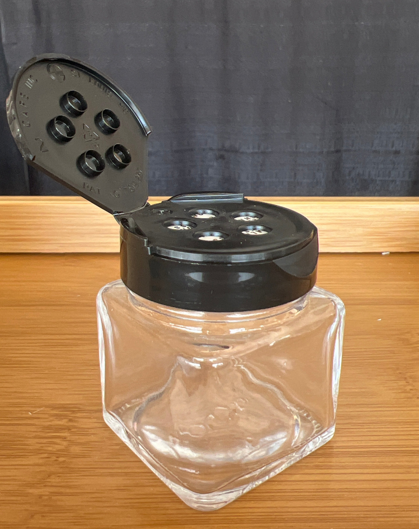 1.5 oz jar with black sifter lid